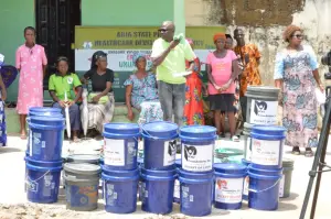 Rows of KMJ Foundation Bucket of Love buckets outside a primary health care center in Abia State