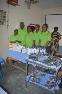 KMJ Foundation volunteers behind a table of medicines at the medical outreach