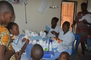 Health workers give out medicines to mothers and children at the KMJ Foundation medical outreach