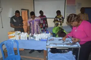Volunteers prepare medicines at the KMJ Foundation outreach pharmacy table