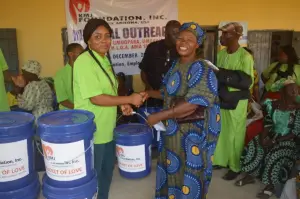 Smiling woman with the KMJ Foundation team at the Bucket of Love distribution